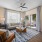 Sunlit living room and dining space at The Morgan Apartments in Chapel Hill, featuring hardwood-style floors and elegant furnishings