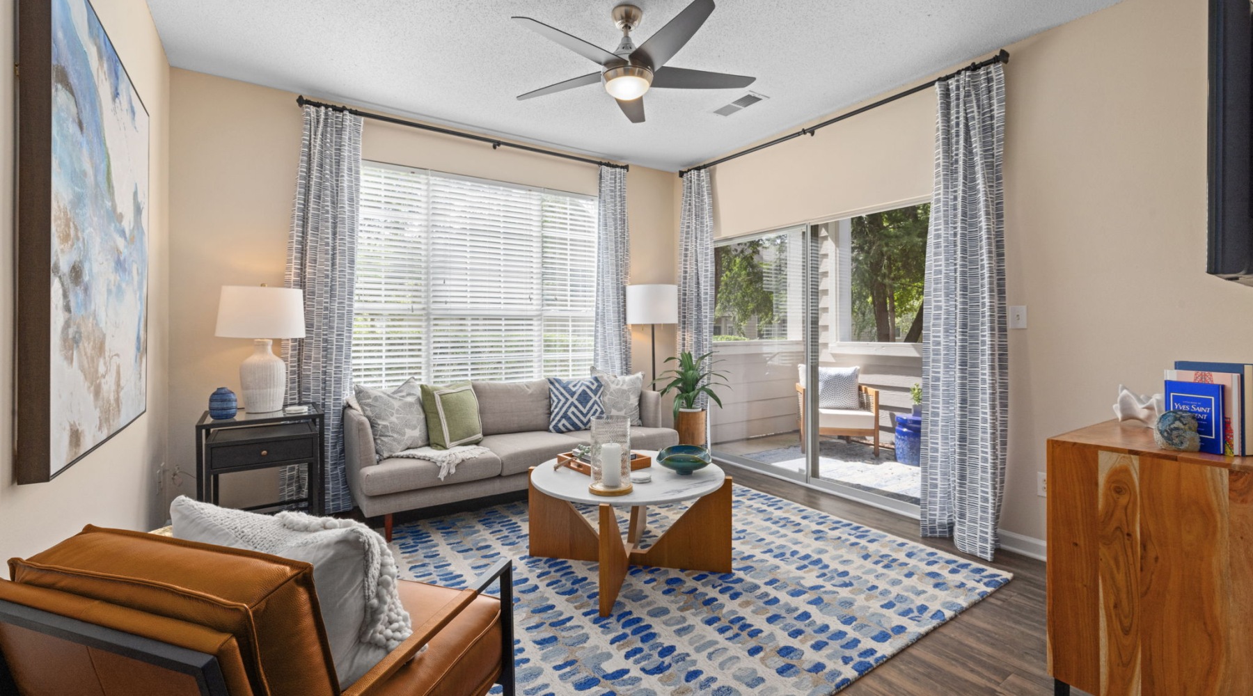 Modern kitchen at The Morgan in Chapel Hill featuring stainless steel appliances, granite countertops, and sleek hardwood-style flooring