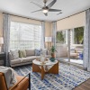 Modern kitchen at The Morgan in Chapel Hill featuring stainless steel appliances, granite countertops, and sleek hardwood-style flooring