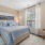 Spacious bedroom at The Morgan Chapel Hill with natural light from large windows, cozy carpet, stylish furniture, and private closet and bathroom
