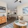 Large bedroom in a model apartment at The Morgan Chapel Hill with carpet flooring, natural light through windows, private bathroom, closet, and contemporary furniture