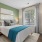 Bright and airy bedroom at The Morgan Chapel Hill featuring natural light, plush carpet, modern bedroom furniture, and private ensuite bathroom and closet.