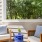 Private balcony at The Morgan Chapel Hill with outdoor furniture, offering scenic views of a peaceful wooded area.