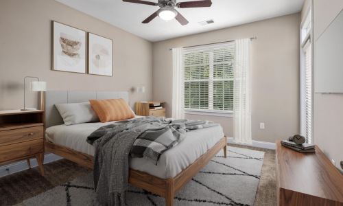 bedroom with large window and ceiling fan