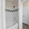 Modern bathroom at The Morgan Chapel Hill featuring granite countertops, hardwood-style flooring, tub/shower combo, tiled walls, and ample cabinet storage