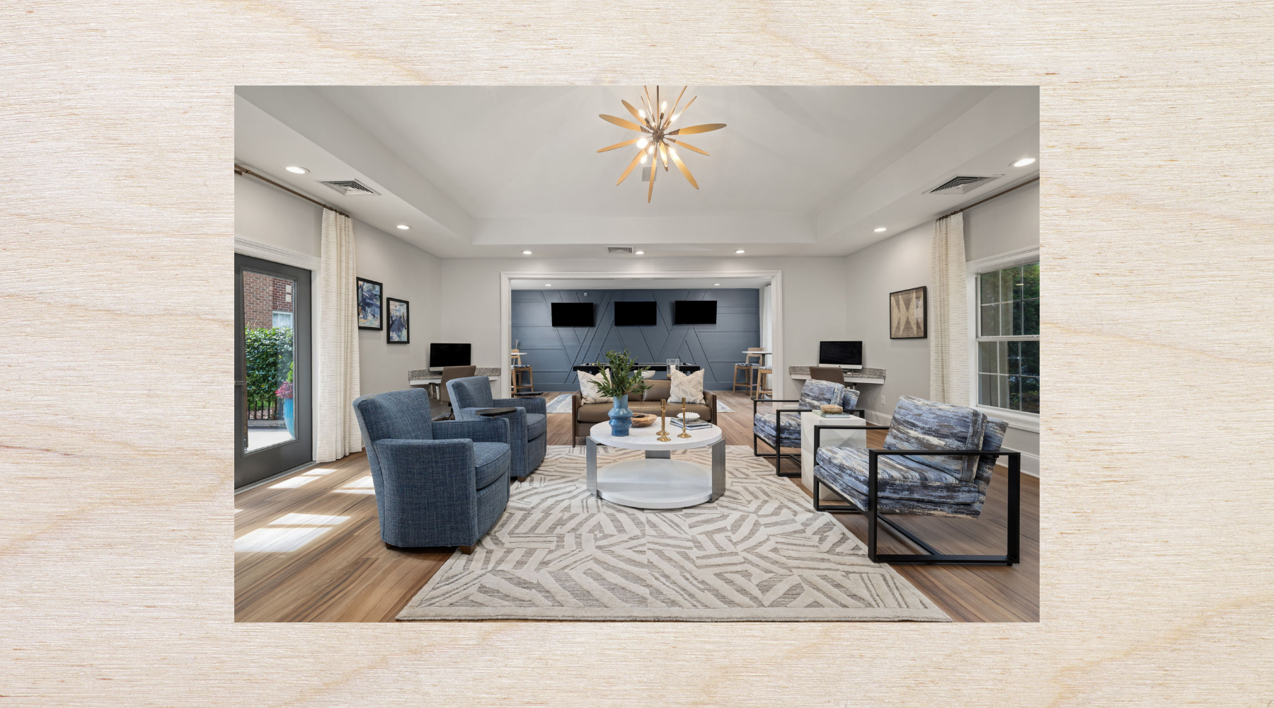 Modern kitchen at The Morgan in Chapel Hill featuring stainless steel appliances, granite countertops, and sleek hardwood-style flooring